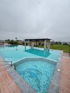 a large swimming pool with blue water at Infinity farm and garden in Bhopal