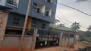 a blue building with a fence in front of it at studio moderne NT Dream House Cameroon in Zalom