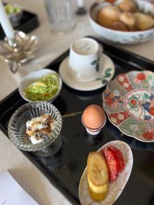 a tray with plates and bowls of food on a table at Riad Camellia in Mitoyo