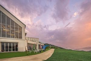 a building on a grass field next to a building at Danyang paramaeul in Danyang +9 photos