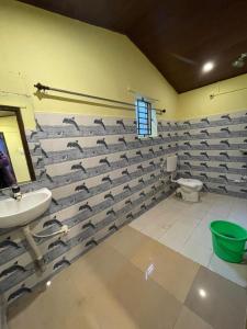a bathroom with a flock of birds on the wall at Gokarna Beach Vibes in Gokarn