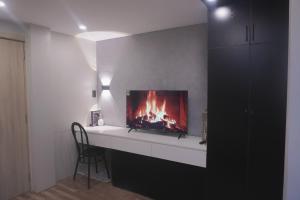 a living room with a fireplace in the wall at Hyn's House in Danang
