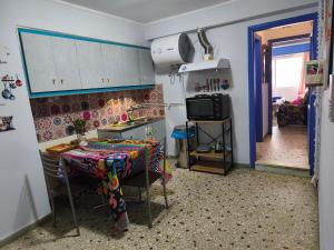 a kitchen with a table and a kitchen with a stove at Studio By The Beach 2 in Saronida