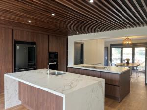 a kitchen with a marble counter top and a island at Faro de Gredos in Arenas de San Pedro