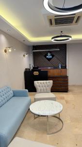 a living room with a blue couch and a table at Taksim Nu Pera Hotel in Istanbul