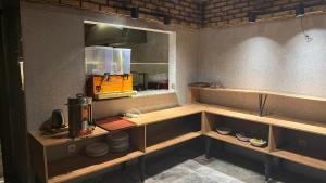 a kitchen with wooden shelves and a counter top at Taksim Nu Pera Hotel in Istanbul