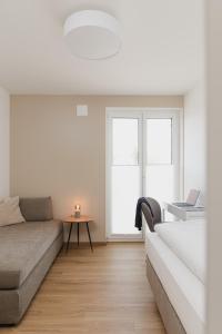 a living room with a couch and a table at LÆKE Apartments - Lindau am Bodensee in Lindau