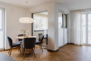 a dining room with a table and chairs at LÆKE Apartments - Lindau am Bodensee in Lindau