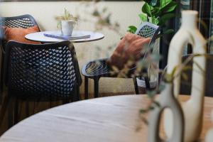 a table and chairs with a table and a table and a table at LÆKE Apartments - Lindau am Bodensee in Lindau