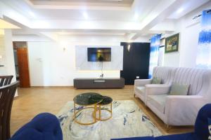 a living room with a couch and a table at Topaz Apartments Shanzu in Mombasa