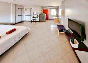 a large room with a bed and a tv at V Village Hotel Saraburi in Ban Muak Lek