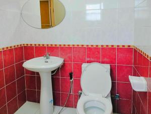 a bathroom with a toilet and a sink and a mirror at V Village Hotel Saraburi in Ban Muak Lek +70 photos