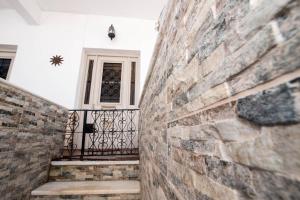 a hallway with a brick wall and a door at Naxian Harmony 300m from the beach in Naxos Chora