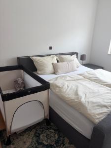 a bedroom with a bed with white sheets and pillows at Ferienwohnung Sensbachtal in Untersensbach