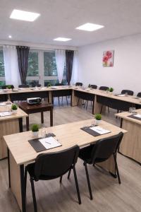 a classroom with tables and chairs in a room at The Originals City, Hôtel Valence Est in Valence