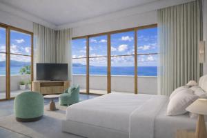 a white bedroom with a large bed and a television at The Bristol Bol - NEW IN 2026 in Bol
