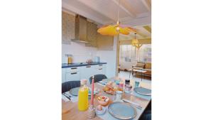 a dining room with a table with plates of food at Bungalow Doris with Hot Tub | 4 persons in Gasselte