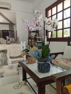 a living room with a table with flowers on it at Aeolos Hotel Apartments in Gythio