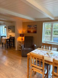 a living room with a table and a chair at Drangedal Cabin House in Drangedal