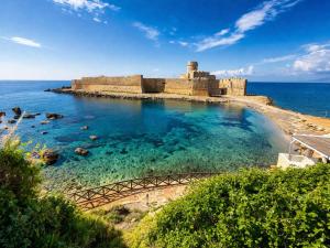 an old castle on an island in the ocean at B&B Capo Rizzuto Armenes in Capo Rizzuto