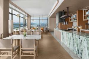 a kitchen and dining room with tables and chairs at The Westin Yichang in Yichang