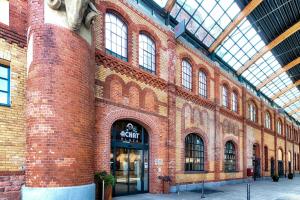 a large brick building with a store in it at Four Points by Sheraton Offenbach Plaza in Offenbach +11 photos