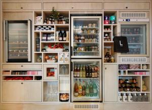 a refrigerator with its doors open with food and drinks at Libertine Lindenberg in Frankfurt/Main
