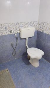 a bathroom with a toilet and a sink at Sea shells on the seashore in Cocoanut Island