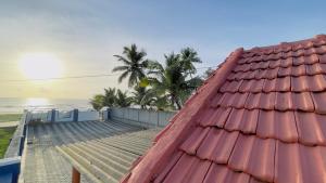 a view of the ocean from the roof of a house at Sea shells on the seashore in Cocoanut Island
