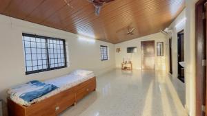 a bedroom with a bed and a wooden ceiling at Sea shells on the seashore in Cocoanut Island