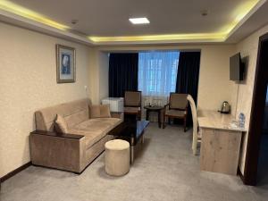 a living room with a couch and a table at Sayohat Hotel in Tashkent