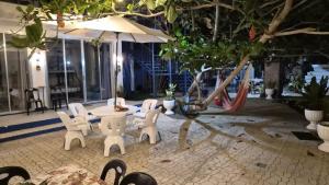 a patio with a table and chairs and an umbrella at Taguilon Hidden Beach Cove Resort in Dapitan