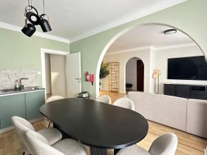 a dining room with a black table and chairs at Sunshine Apt in Central Sliema in Sliema