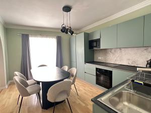 a kitchen with a table and chairs in a kitchen at Sunshine Apt in Central Sliema in Sliema +24 photos