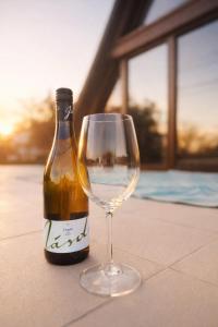 a bottle of wine sitting next to a wine glass at Spicc house in Csopak +8 photos