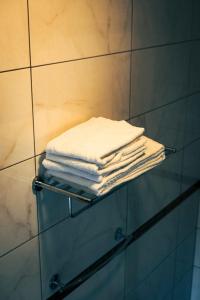 a stack of towels on a towel rack in a bathroom at Ostsee Hotel Travemünde in Travemünde +43 photos
