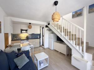a living room with a staircase and a kitchen at Casa Hugo in Costa Calma