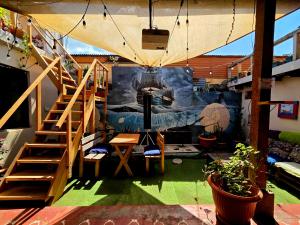 a room with a staircase and a table and a stair case at Amura Hostel - Antigua Guatemala in Antigua Guatemala