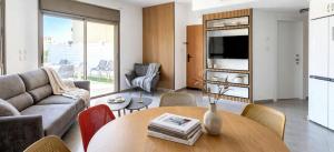 a living room with a table and a couch at Amdar Holiday Apartments in Eilat