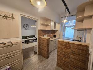 a kitchen with a brick wall and a clock on the wall at Epic rooms in Braşov