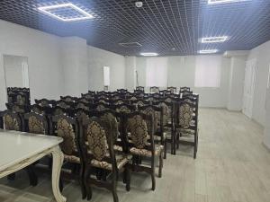 a room with a bunch of chairs and a table at Панський Двір 2 in Chernivtsi