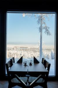 a table with two laptops on it in front of a window at Arctic Lumo Resort in Kuusamo +55 photos