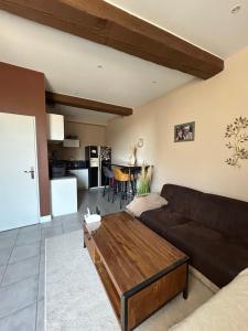 a living room with a couch and a table at Appartement Bellegarde in Bellegarde