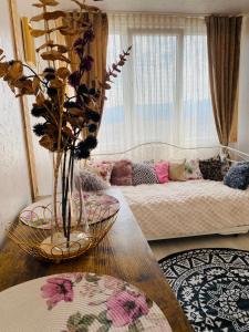 a living room with a couch and a table at Panorama Lupilor in Coleşti +63 photos