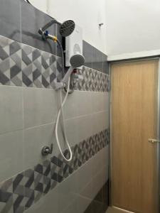 a shower with a blow dryer in a bathroom at Miraana Nest in Sungai Petani