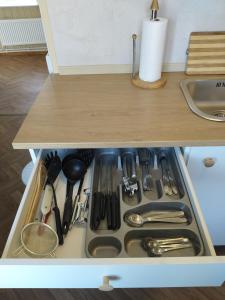 a drawer in a cabinet filled with utensils at Parkal Apartments in Paide +13 photos