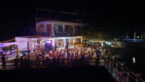 a group of people standing outside of a building at night at Taguilon Hidden Beach Cove Resort in Dapitan +33 photos