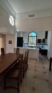 a dining room with a large wooden table and chairs at Villa maryama in Marrakesh