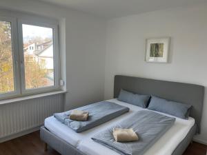 a bedroom with a bed with two pillows on it at Schlafen am Weiher in Günzburg