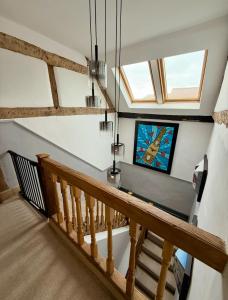 a staircase with a wooden rail and a window at City Rooms by Hiive in Worcester